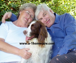 Couple and their dog english spaniel having a cuddle